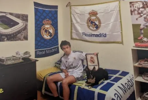 luca in his real madrid styled room with his dog